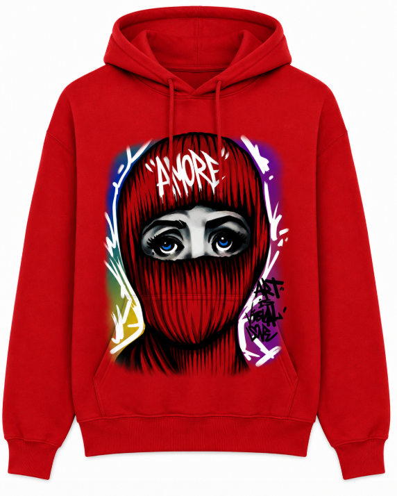 A red pullover hoodie featuring a large graphic print of a face wearing a red balaclava with blue eyes, white graffiti-style text reading 'AMORE', and colorful paint splatter details on the front.